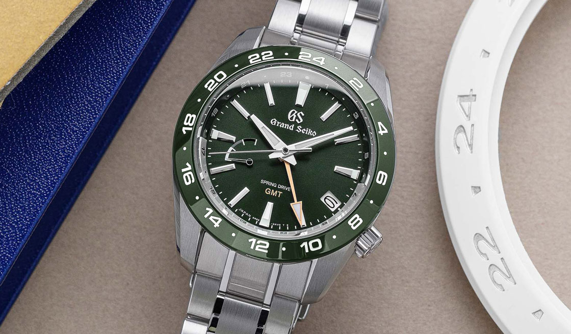 Grand Seiko SBGE257 green dial sport watch with golden accents.