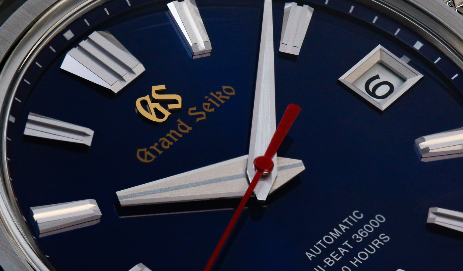 Close up of Grand Seiko SLGH003 blue dial with red and golden accents.